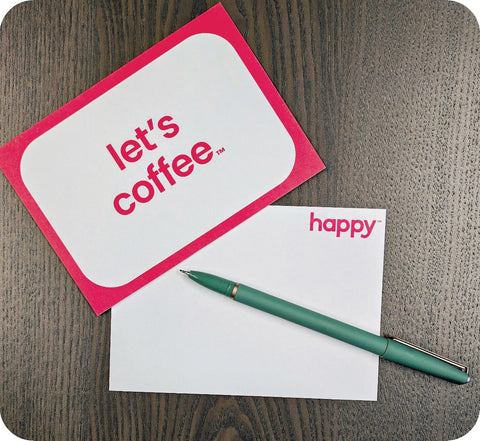 a Postcard that says lets coffee with a pen ready to write